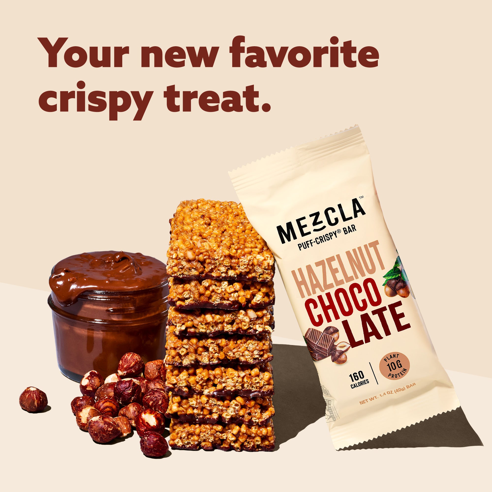 Mezcla Hazelnut Chocolate puff-crispy bar package with stacked bar pieces, chocolate spread jar, and scattered hazelnuts on beige background