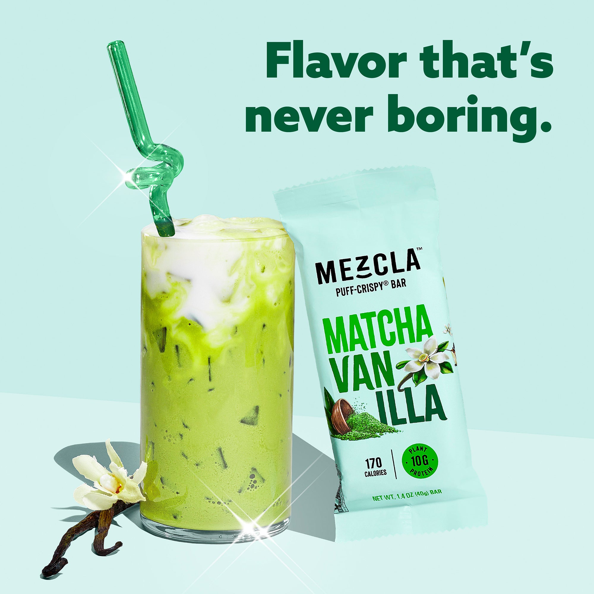 Green matcha vanilla smoothie with bent straw next to Mezcla protein bar package on mint background with vanilla beans
