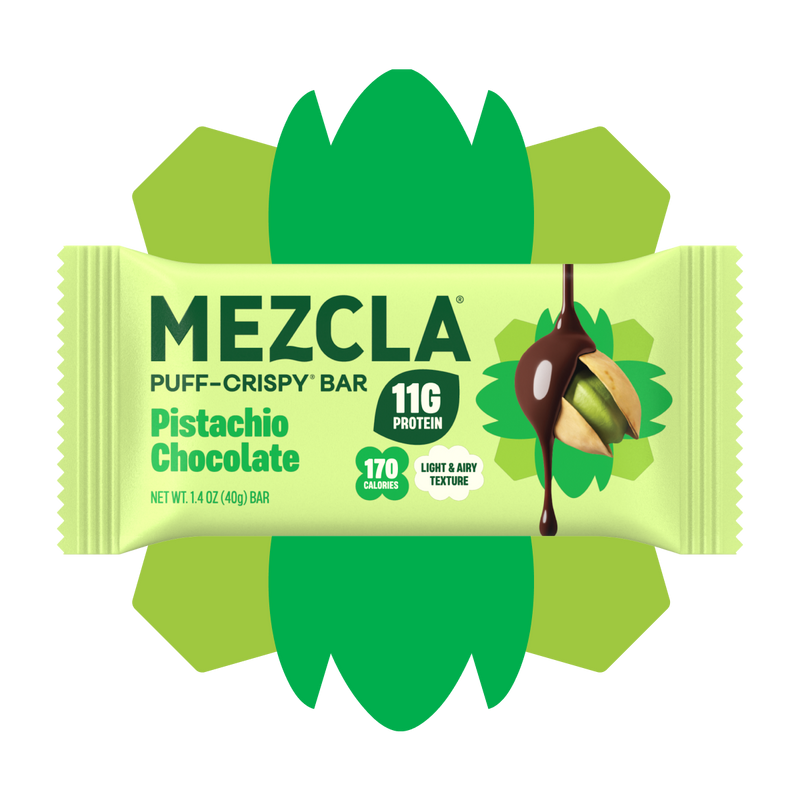 Mezcla Pistachio Chocolate puff-crispy protein bar package in green wrapper with decorative flower design, showing 11g protein and 170 calories