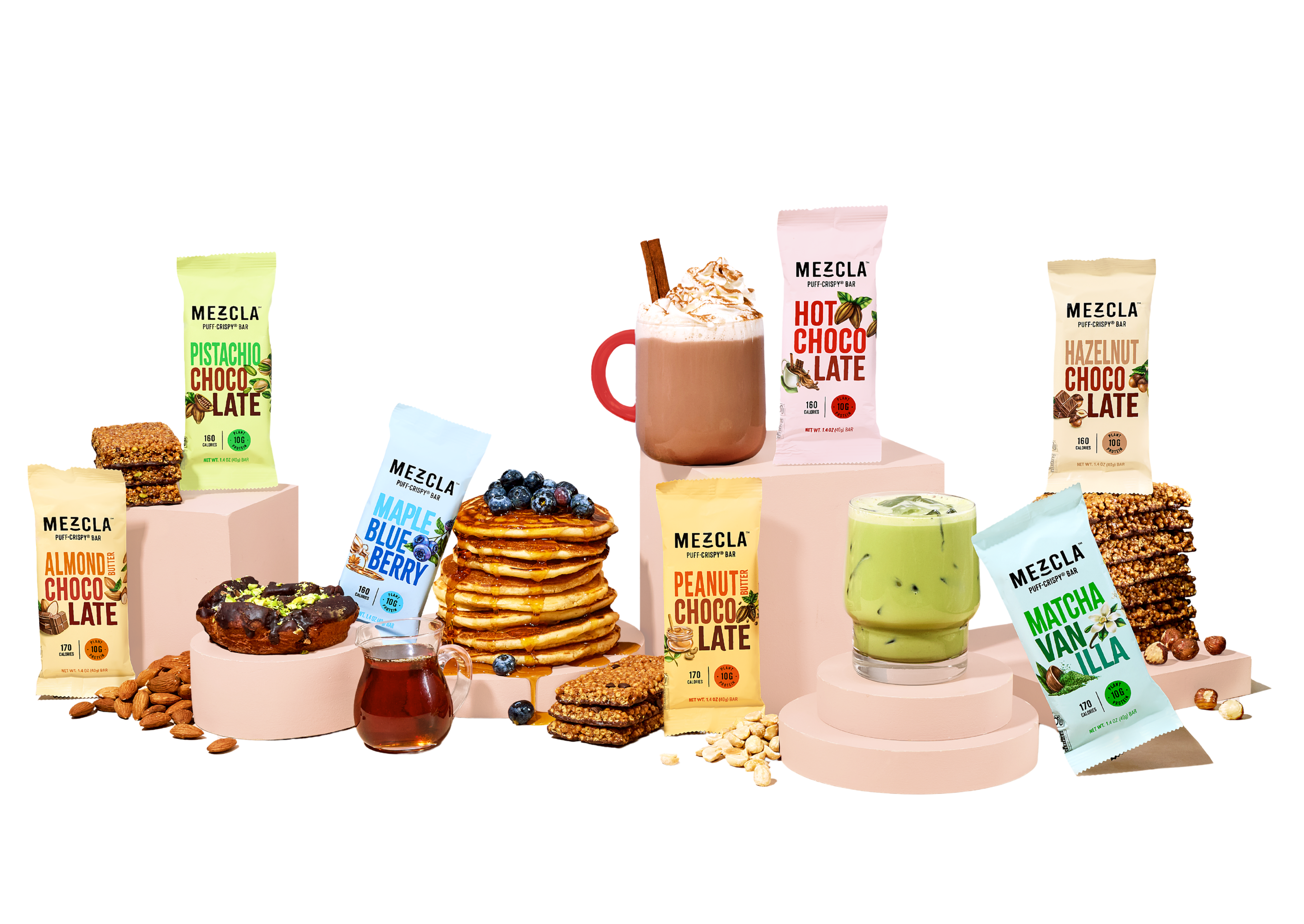 Pistachio chocolate and almond butter chocolate bars surrounded by pistachios and almond butter